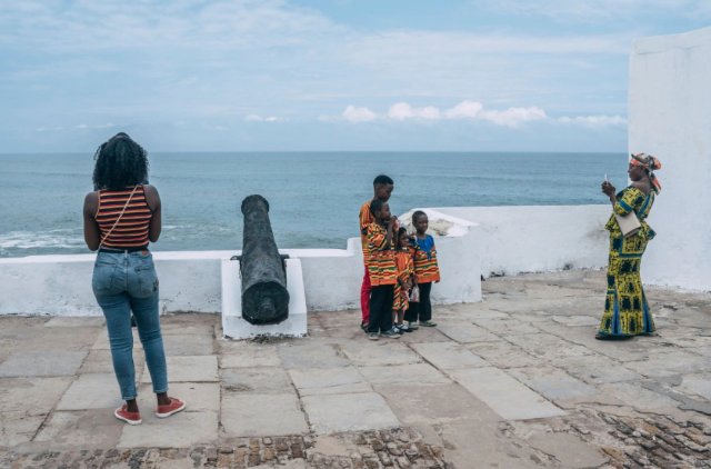 Tourists pose for pictures at the Cape Coast Castle in Ghana on Aug. 18, 2019