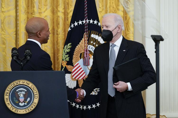 President Biden shakes hands with Dr. Edjah Nduom at the White House. Biden on Wednesday announced a renewed push to fight cancer, an initiative that he said could dramatically reduce cancer deaths over the next 25 years. (Alex Brandon / Associated Press).