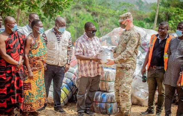 US Army Major Jarrod Simek of the Office of Security Cooperation presenting the items