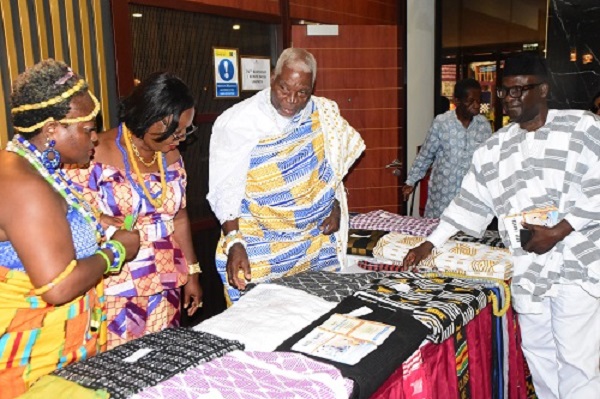 Torgbui Gobah Tengey Seddoh (second from right) inspecting some of the cloths on exhibition