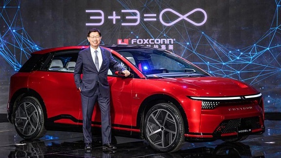 Foxconn chairman Young Liu with one of the firm's electric cars