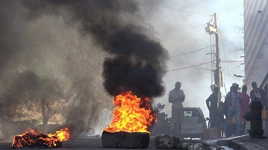 Tyres were set on fire outside the main prison in the Haitian capital, Port-au-Prince